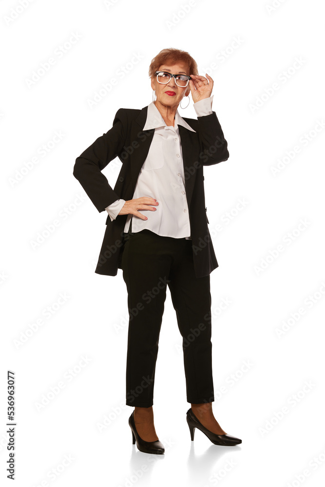 Portrait of confident senior executive manager. Stylish middle age woman in black business suit posing isolated on white background Portrait of confident senior executive manager. Stylish middle age woman in black business suit posing isolated on white background