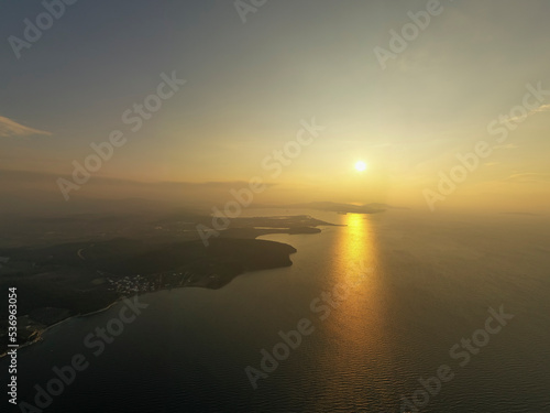 Aerial photography, sunset shot with sun light on horizon and light on sea