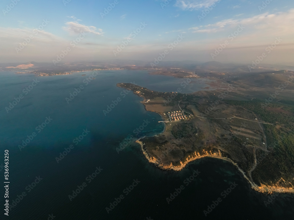 Aerial photography, island on sea with turquoise water and blue cloudy sky