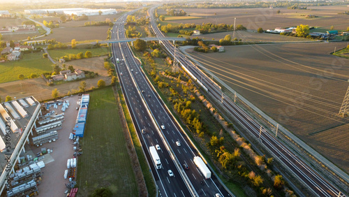 aerial photo highway tollway a1 autostrada del sole in Piacenza Italy at sunset
