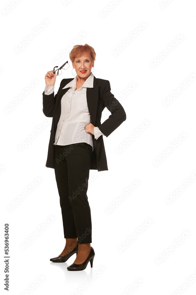 Portrait of confident senior executive manager. Stylish middle age woman in black business suit posing isolated on white background Portrait of confident senior executive manager. Stylish middle age woman in black business suit posing isolated on white background