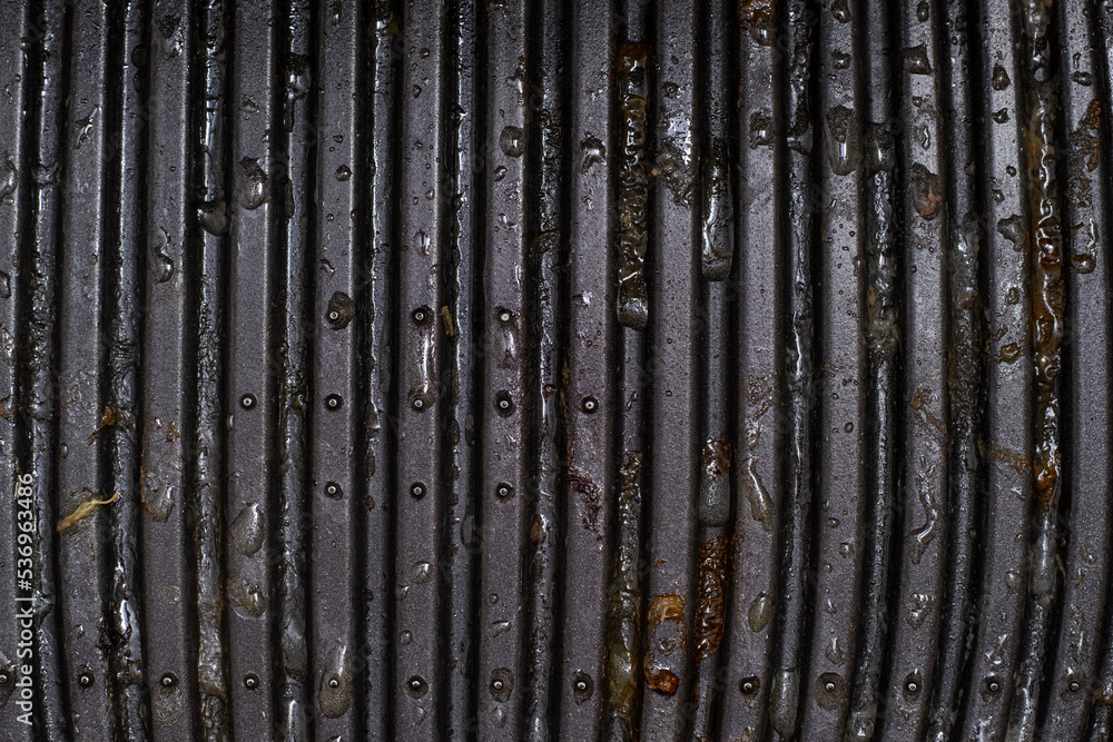 Grill surface in grease after use. Flat lay, top view. Grill surface in grease after use. Flat lay, top view.