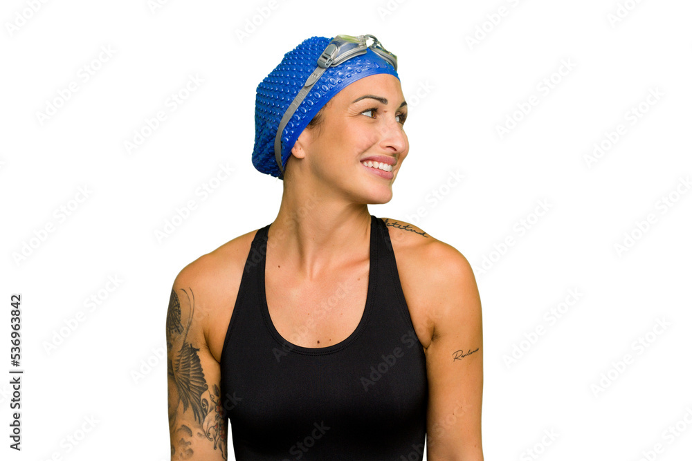 Young caucasian swimmer woman isolated on green chroma background looks aside smiling, cheerful and pleasant. Young caucasian swimmer woman isolated on green chroma background looks aside smiling, cheerful and pleasant.