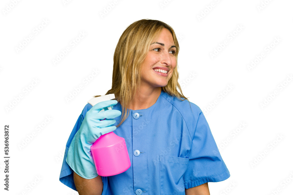 Young cleaner caucasian woman isolated green chroma background looks aside smiling, cheerful and pleasant. Young cleaner caucasian woman isolated green chroma background looks aside smiling, cheerful and pleasant.