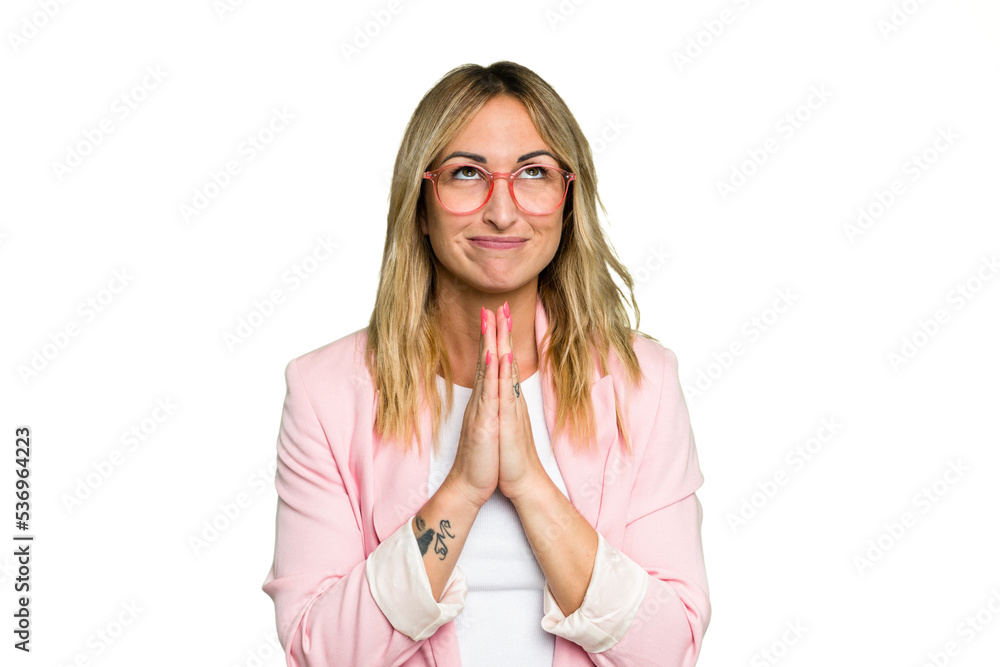 Young caucasian woman isolated on green chroma background holding hands in pray near mouth, feels confident. Young caucasian woman isolated on green chroma background holding hands in pray near mouth, feels confident.