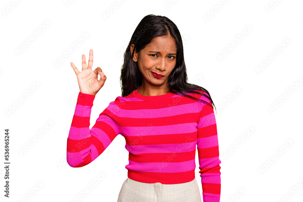 Young Indian woman isolated winks an eye and holds an okay gesture with hand. Young Indian woman isolated winks an eye and holds an okay gesture with hand.