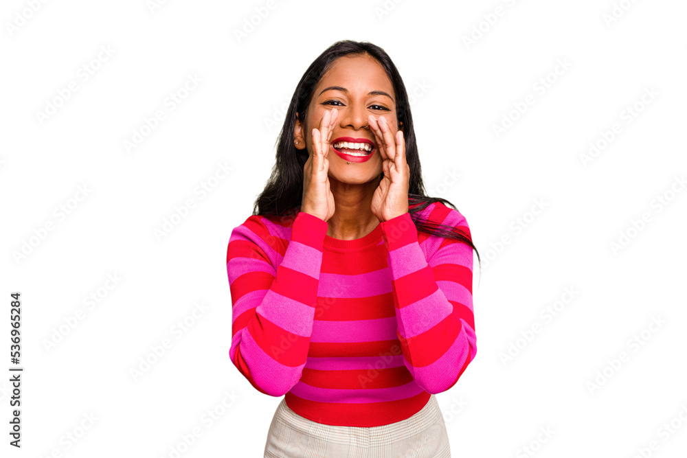 Fototapeta premium Young Indian woman isolated saying a gossip, pointing to side reporting something.