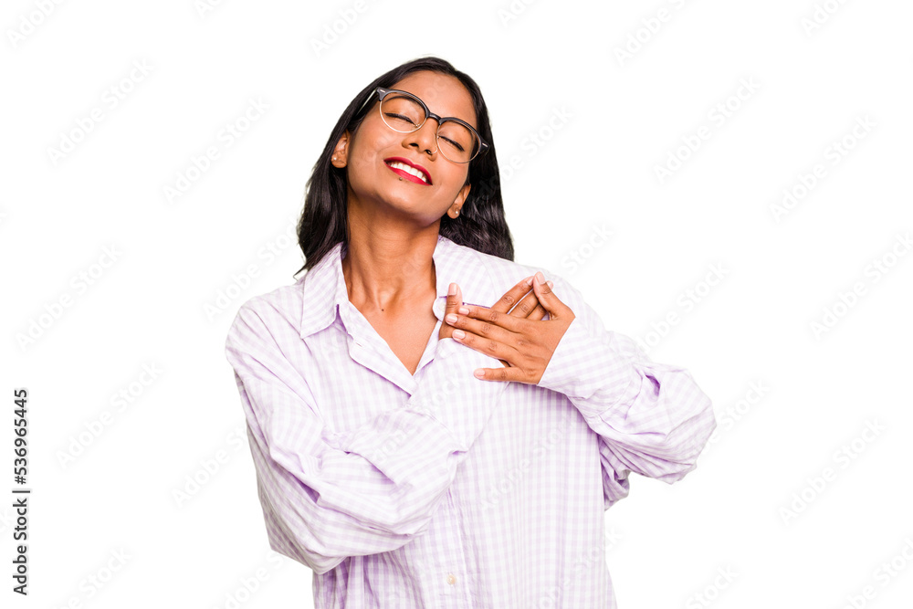 Young Indian woman isolated has friendly expression, pressing palm to chest. Love concept. Young Indian woman isolated has friendly expression, pressing palm to chest. Love concept.