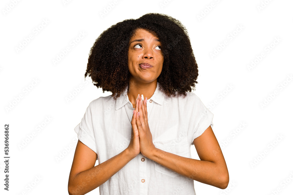 Young African American woman isolated holding hands in pray near mouth, feels confident. Young African American woman isolated holding hands in pray near mouth, feels confident.