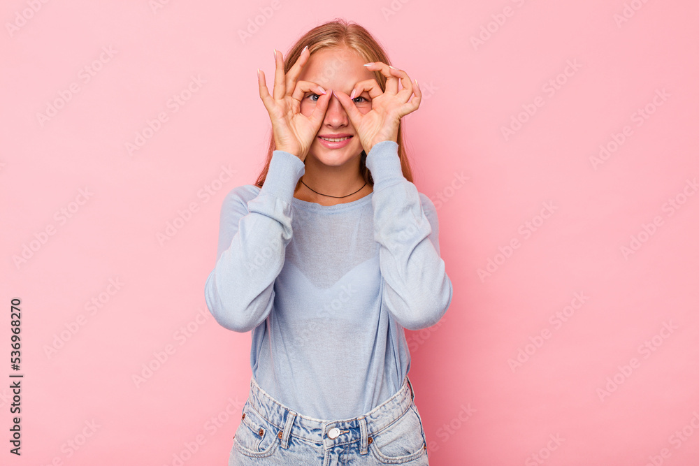 Caucasian teen girl isolated on pink background excited keeping ok gesture on eye. Caucasian teen girl isolated on pink background excited keeping ok gesture on eye.