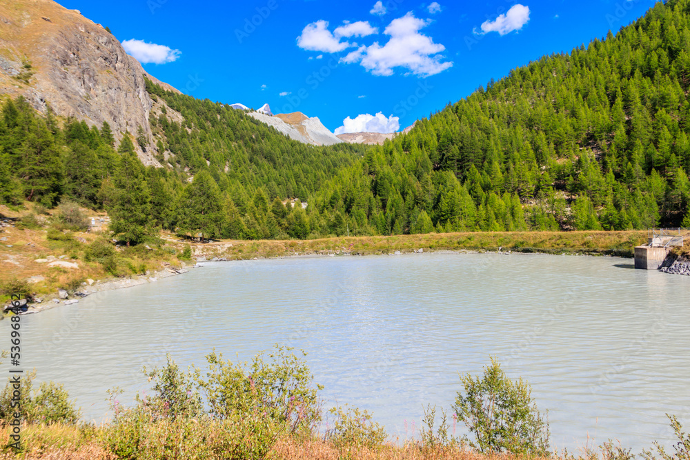 View of Moosjisee lake and the Swiss Alps at summer on the Five Lakes Trail in Zermatt, Switzerland