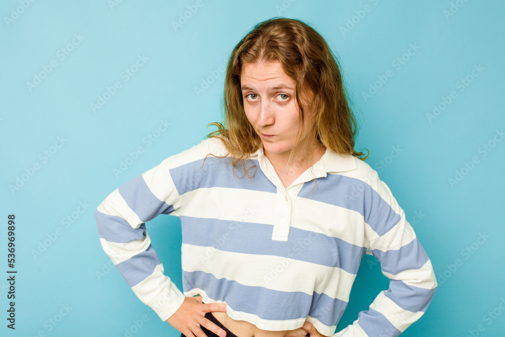 Young caucasian woman isolated on blue background confused, feels doubtful and unsure. Young caucasian woman isolated on blue background confused, feels doubtful and unsure.