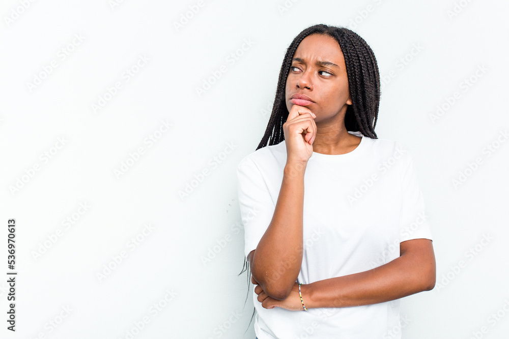 Young African American woman isolated on white background looking sideways with doubtful and skeptical expression. Young African American woman isolated on white background looking sideways with doubtful and skeptical expression.
