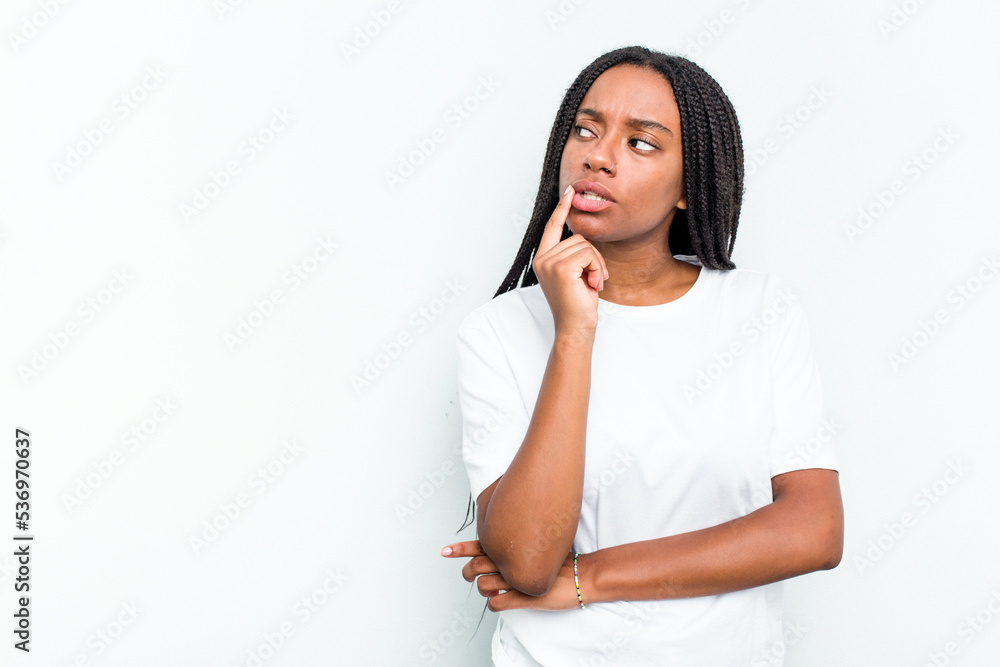 Young African American woman isolated on white background looking sideways with doubtful and skeptical expression. Young African American woman isolated on white background looking sideways with doubtful and skeptical expression.
