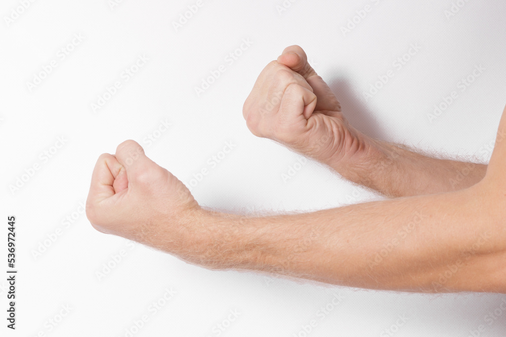 male hands clenched into fists on a white male hands clenched into fists on a white