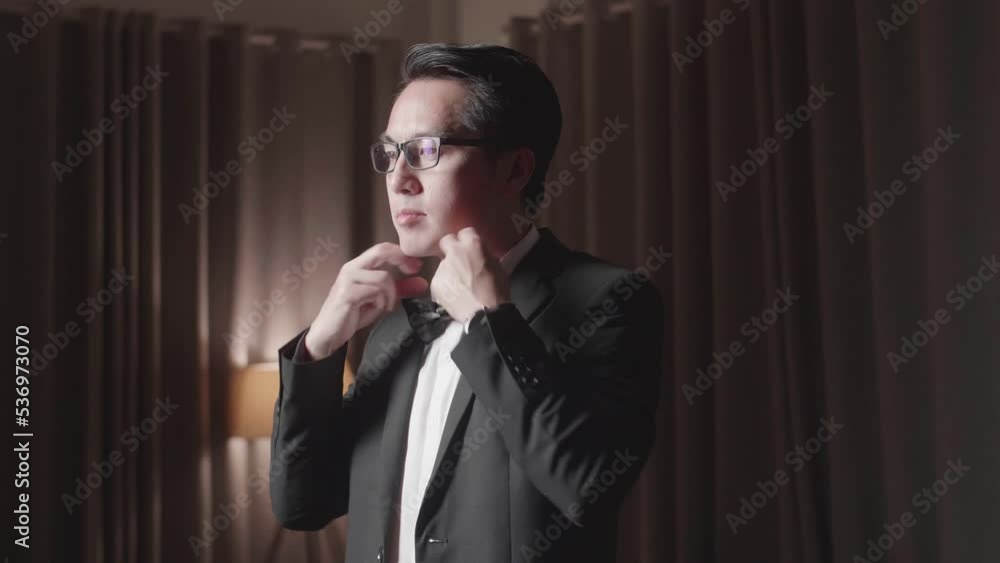 Asian Man In Jacket And White Classic Shirt Wearing Black Bowtie. Dressing For Celebration Event, Business Meeting Or Wedding
Asian Man In Jacket And White Classic Shirt Wearing Black Bowtie. Dressing For Celebration Event, Business Meeting Or Wedding