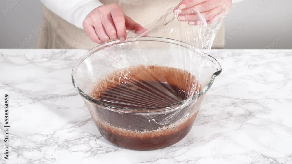 Preparing chocolate ganache in a glass mixing bowl. Preparing chocolate ganache in a glass mixing bowl.
