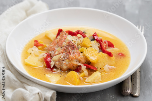 typical portuguese fish stew on white plate on ceramic