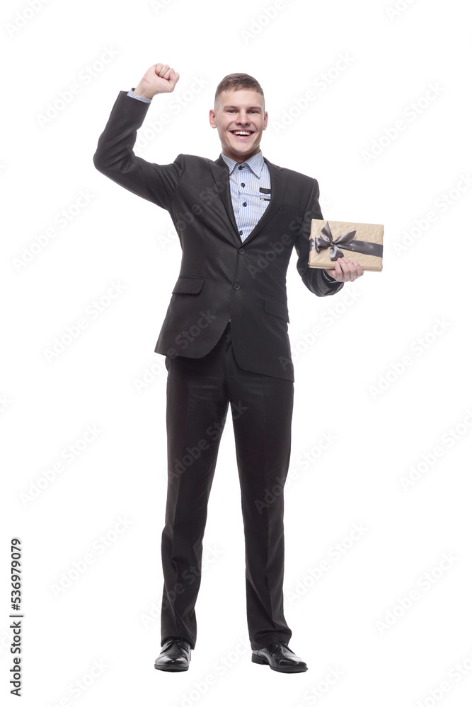 in full growth. happy young businessman with a gift box . in full growth. happy young businessman with a gift box .