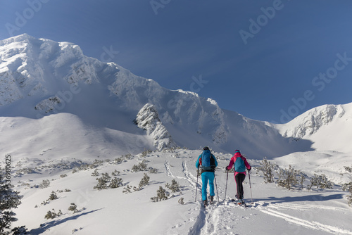 Ski touring couple hiking up a mountain in the Low Tatras in Slovakia. Rear view. © Halfpoint