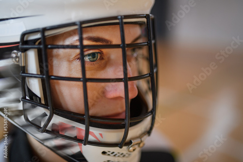 Canvas Print Close-up of woman floorball goalkeeper in helmet concetrating on game in gym