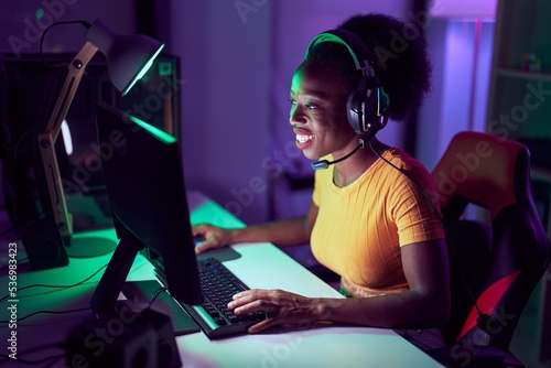 African american woman streamer using computer at gaming room