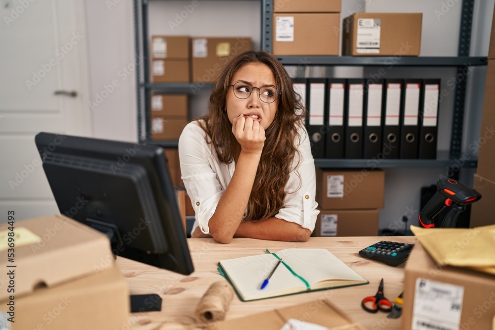 Young hispanic woman working at small business ecommerce thinking worried about a question, concerned and nervous with hand on chin Young hispanic woman working at small business ecommerce thinking worried about a question, concerned and nervous with hand on chin