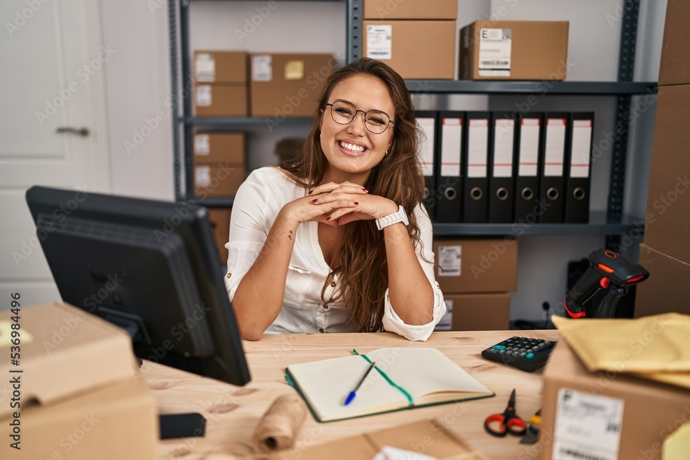 Young hispanic woman working at small business ecommerce with a happy and cool smile on face. lucky person. Young hispanic woman working at small business ecommerce with a happy and cool smile on face. lucky person.