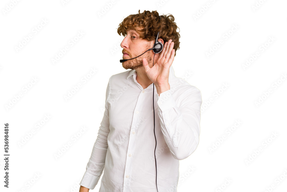 Telemarketer man working with a headset isolated on green chroma background trying to listening a gossip.