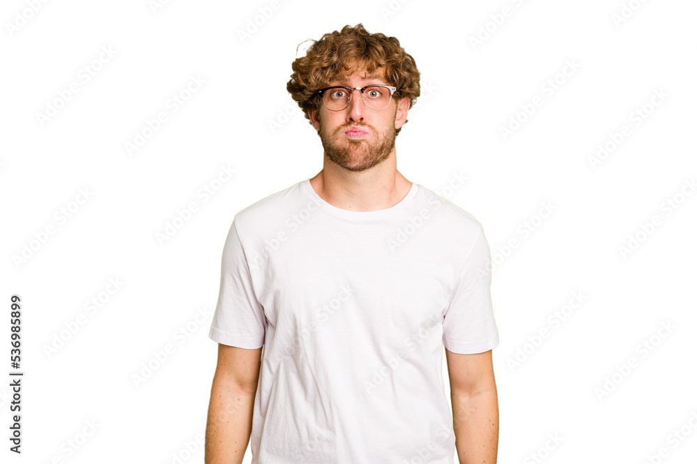 Young caucasian man isolated on green chroma background blows cheeks, has tired expression. Facial expression concept. Young caucasian man isolated on green chroma background blows cheeks, has tired expression. Facial expression concept.