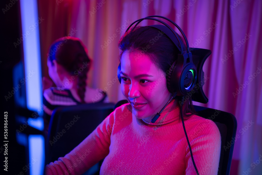An active and serious young woman gamer on his powerful personal computer, playing first-person online video games. An active and serious young woman gamer on his powerful personal computer, playing first-person online video games.
