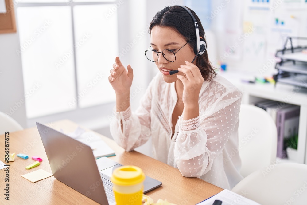 Young hispanic woman call center agent having video call at office Young hispanic woman call center agent having video call at office