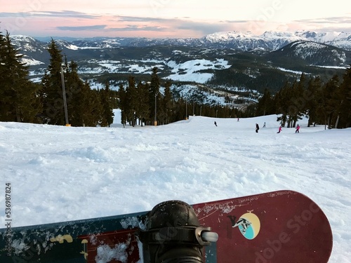 Snowboarder resting on Mount Washington in British Columbia, Canada