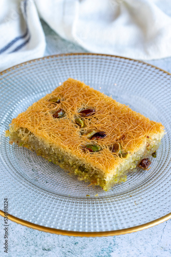 Pistachio Kadaif dessert. Traditional Mediterranean cuisine delicacies. Kadayif on gray background. close up