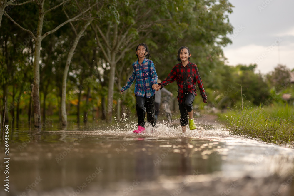 Children playing water on flooding in rural 