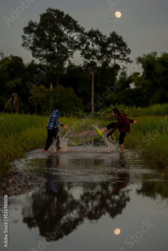 Children playing on flooding in rural 
