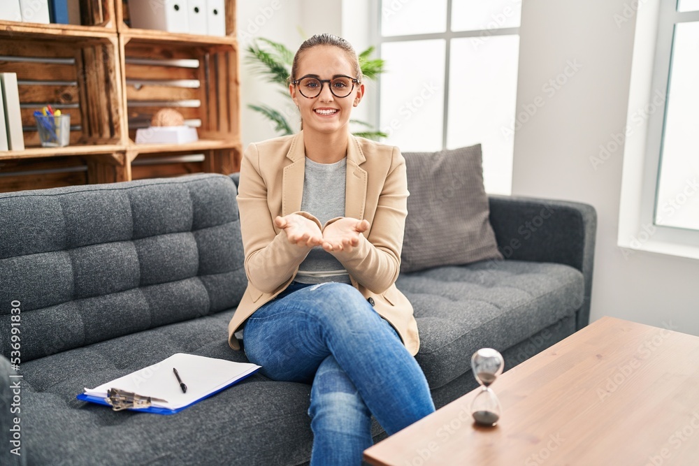 Young woman working at consultation office smiling with hands palms together receiving or giving gesture. hold and protection Young woman working at consultation office smiling with hands palms together receiving or giving gesture. hold and protection