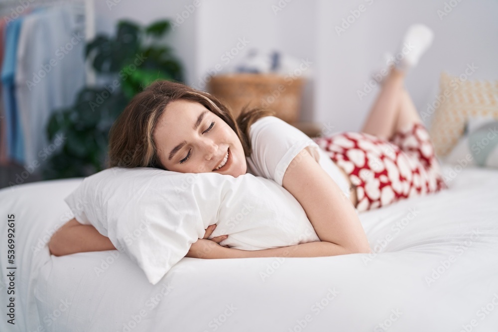 Young woman smiling confident lying on bed at bedroom Young woman smiling confident lying on bed at bedroom