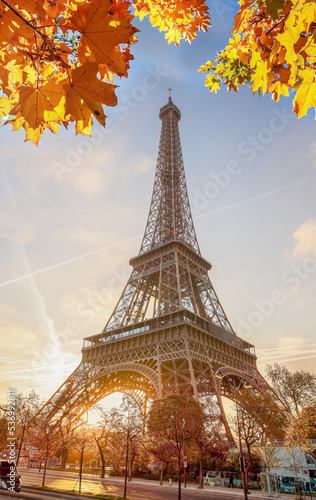 Eiffel Tower with autumn leaves against colorful sunset in Paris, France © Tomas Marek