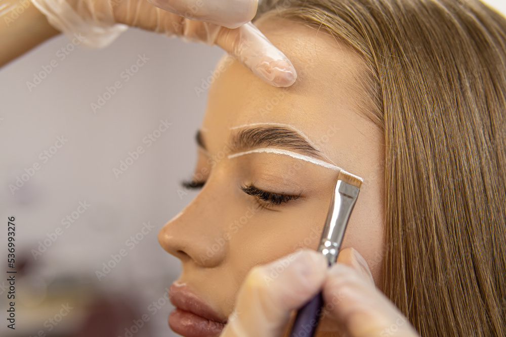 Marking of eyebrows. Permanent brow makeup. Markings with white paste