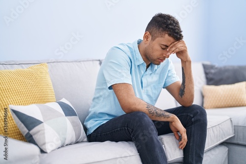African american man stressed sitting on sofa at home © Krakenimages.com