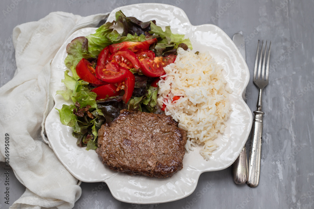 three fried ground meat with fresh salad on white plate three fried ground meat with fresh salad on white plate