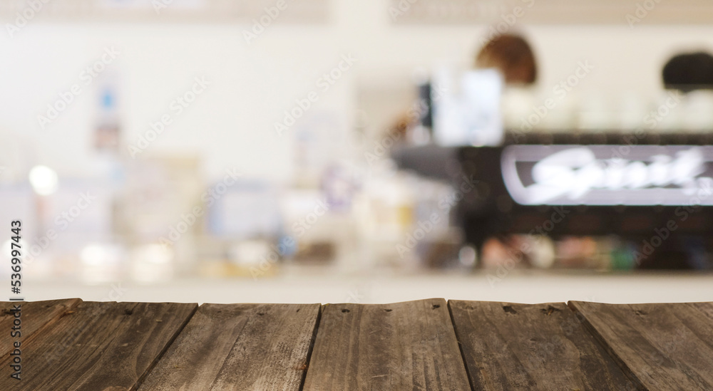 Wood top table with Blur coffee shop or cafe restaurant with abstract bokeh light image background. People in store Blur Background or design key visual layout Wood top table with Blur coffee shop or cafe restaurant with abstract bokeh light image background. People in store Blur Background or design key visual layout