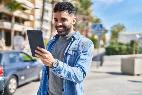Young hispanic man smiling confident having video call at street © Krakenimages.com