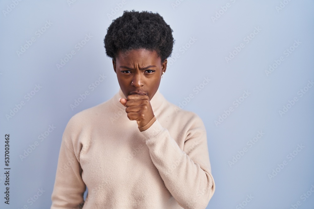 African american woman standing over blue background feeling unwell and coughing as symptom for cold or bronchitis. health care concept. African american woman standing over blue background feeling unwell and coughing as symptom for cold or bronchitis. health care concept.