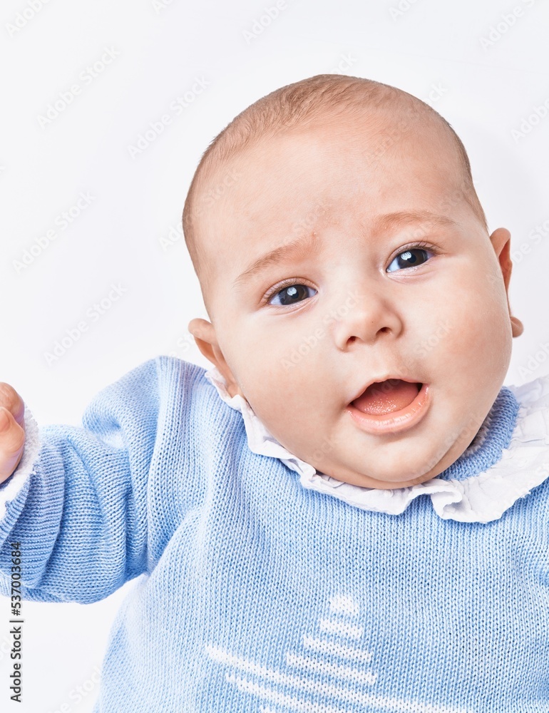 Adorable baby smiling confident lying on bed over white isolated background Adorable baby smiling confident lying on bed over white isolated background
