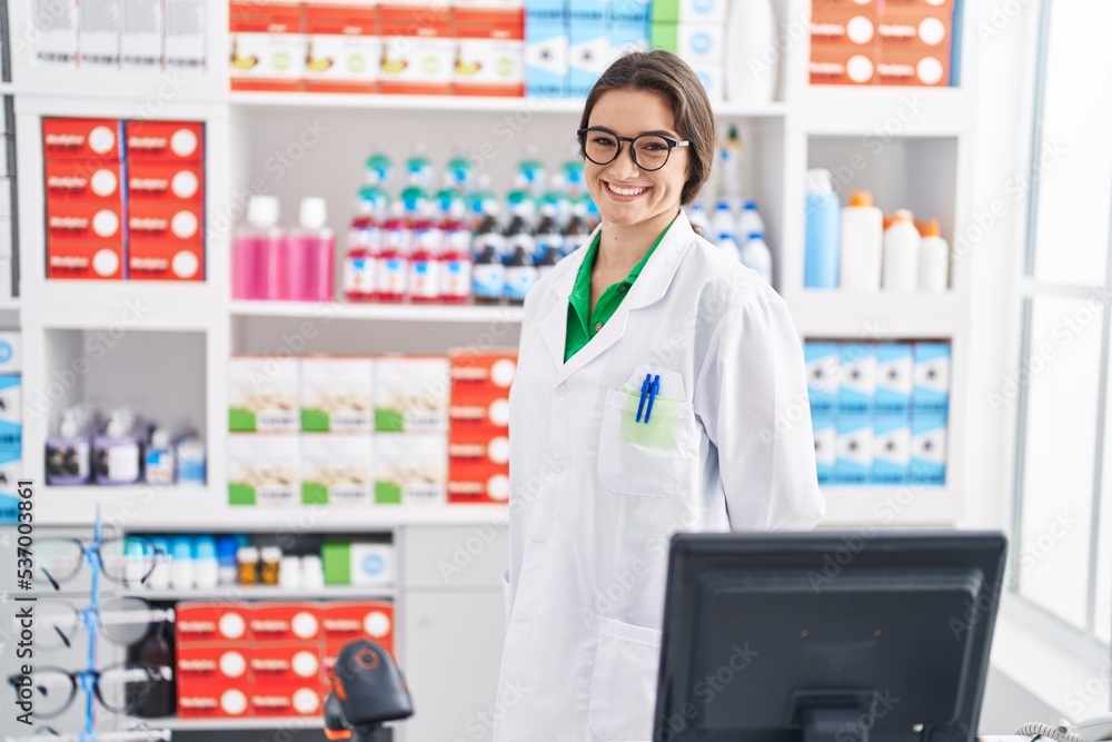 Young hispanic woman pharmacist smiling confident standing at pharmacy Young hispanic woman pharmacist smiling confident standing at pharmacy