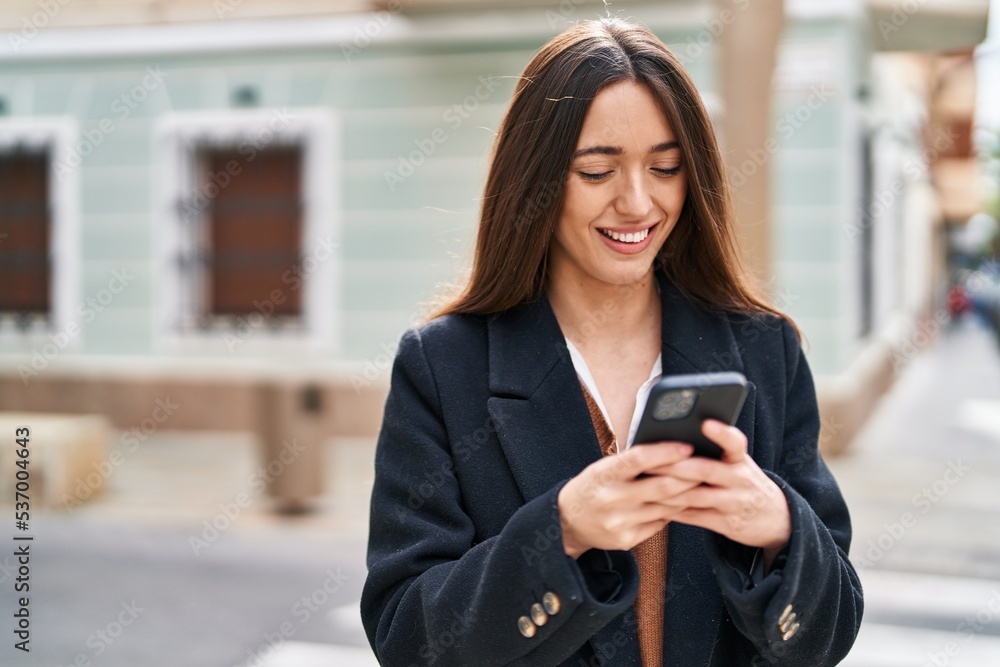 Young beautiful hispanic woman smiling confident using smartphone at street Young beautiful hispanic woman smiling confident using smartphone at street
