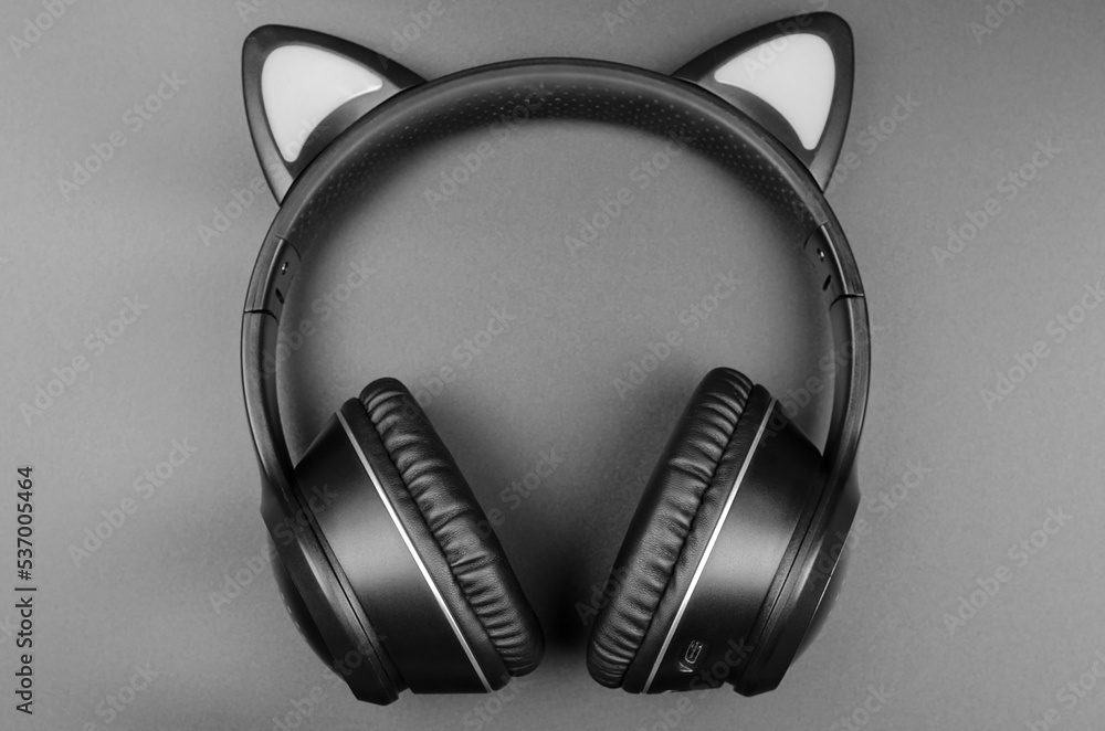 Black wireless headphones on a black background Black wireless headphones on a black background
