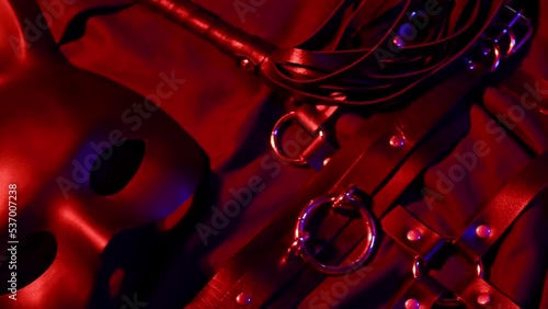 Vibrator, whip, handcuffs and mask for BDSM sex with submission and domination. A set of adult erotic sex toys